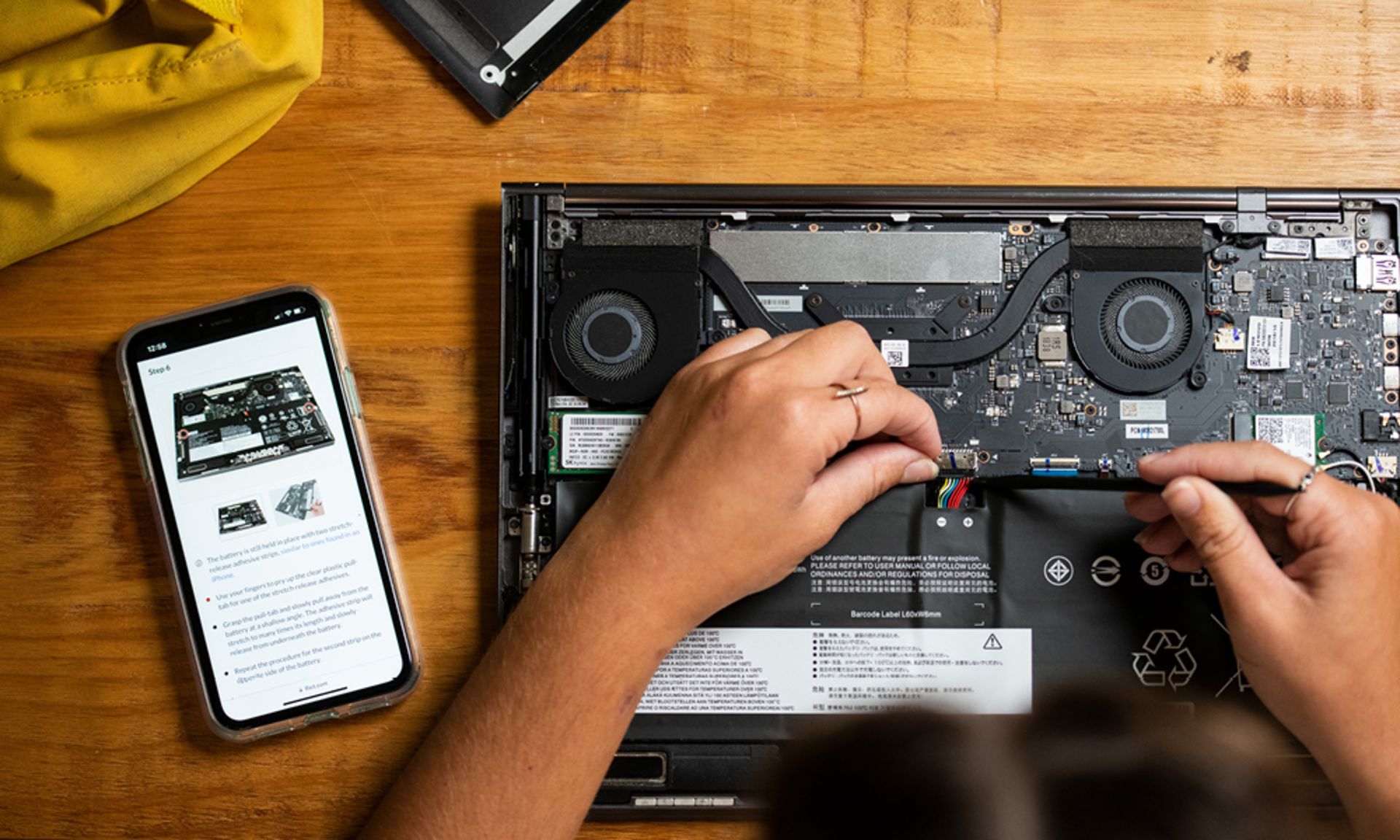 A person is repairing a laptop