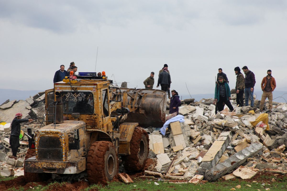 Debris removal by rescuers in the Syrian city of Jendires