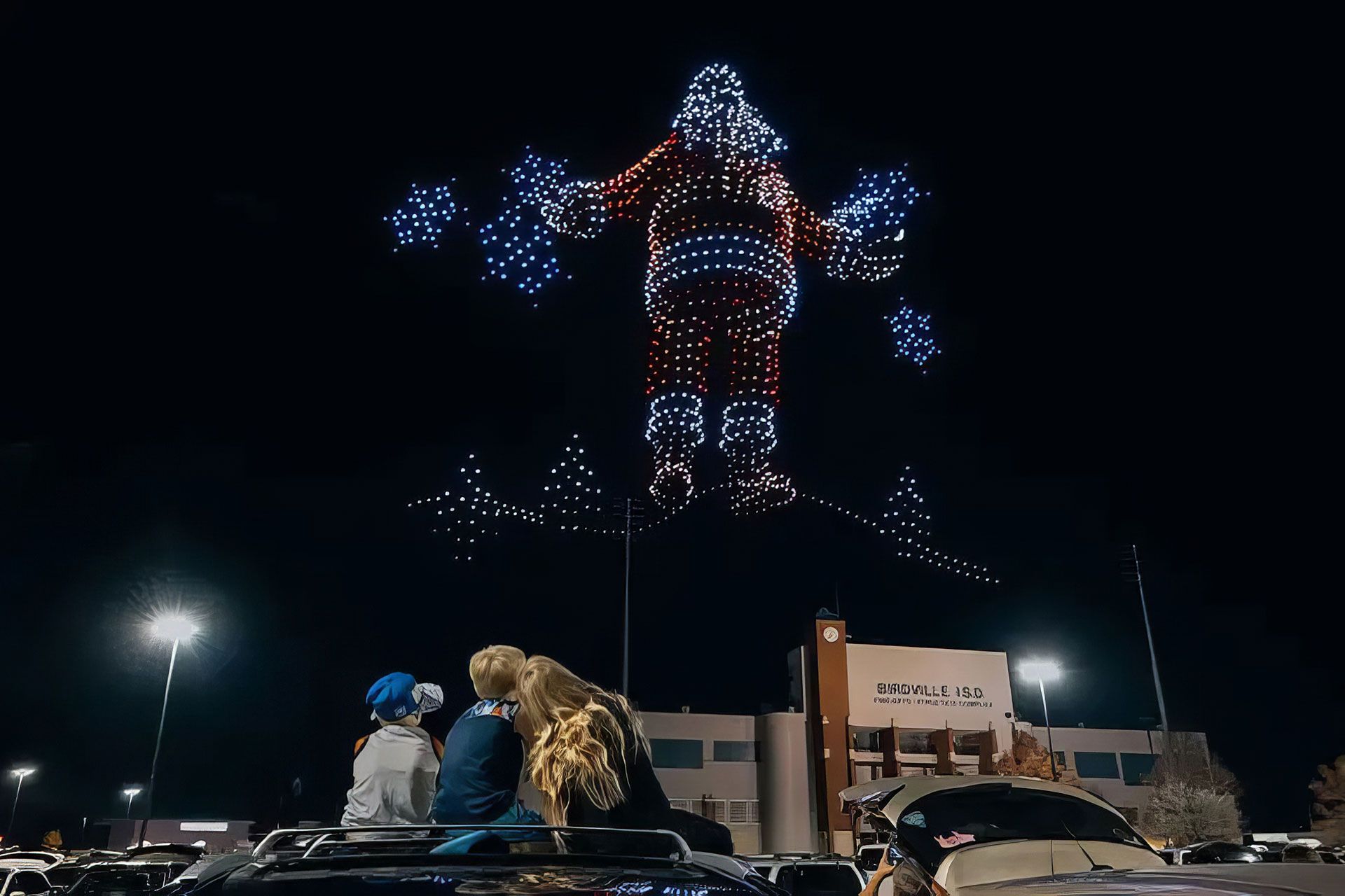 نمایی از نمایش نوری هوایی ۱۴۹۹ پهپاد که شخصیت بابانوئل را در آسمان شب به تصویر کشیده‌اند.