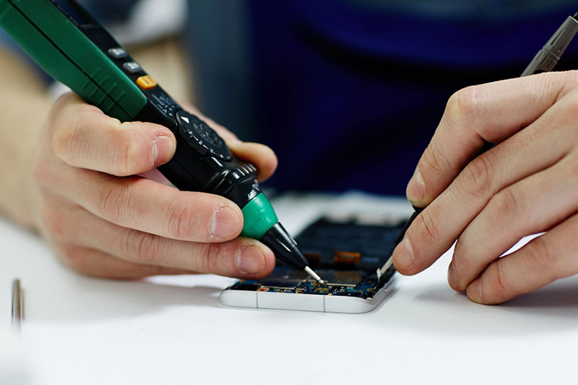 شخصی درحال تعمیر گوشی
