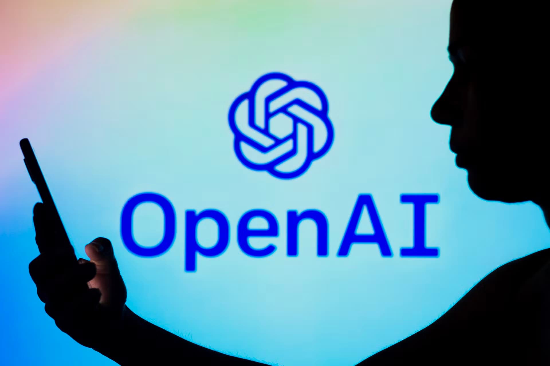 someone using phone openai logo dark shadow 6410b79afc5aadb2f17063bd