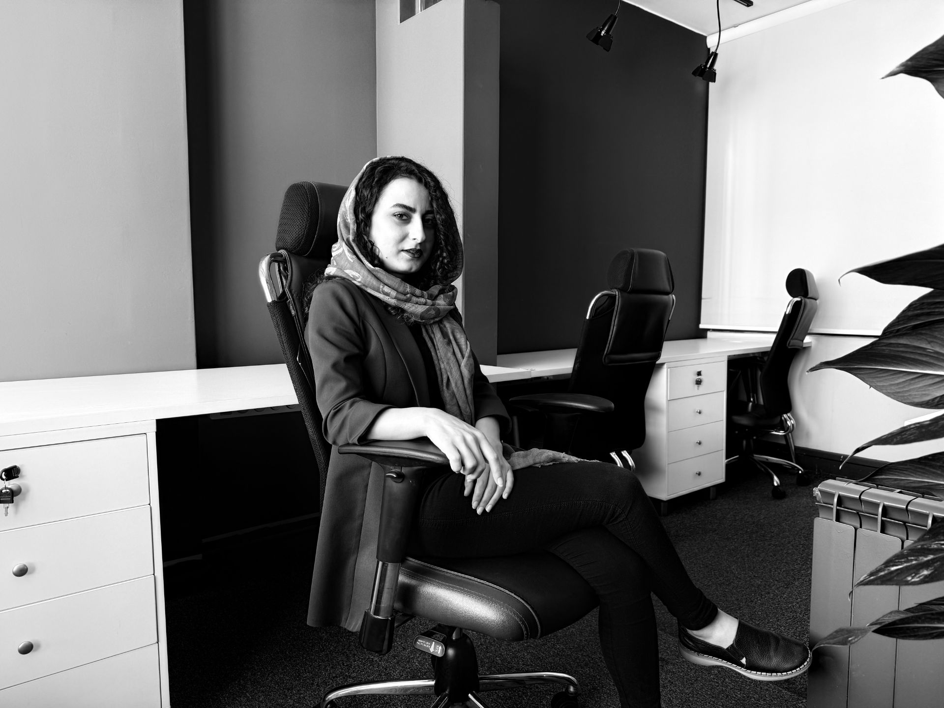 Kausar Nikomanesh, Zomit writer in the editorial office - Stark B&W iPhone 16 Pro photography style