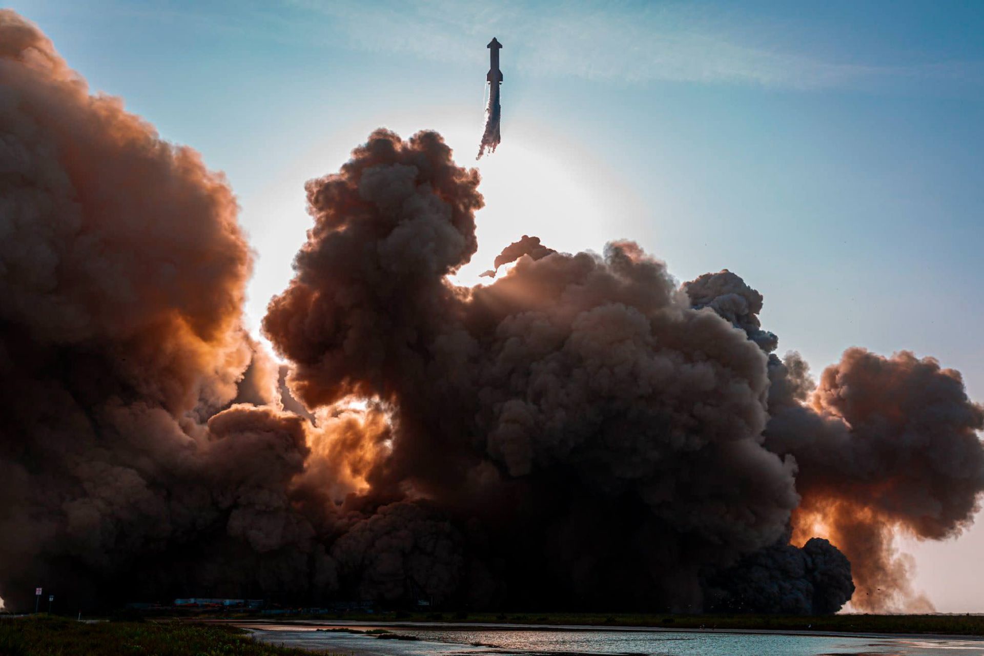 Starship and superhive flying over a huge plume of smoke