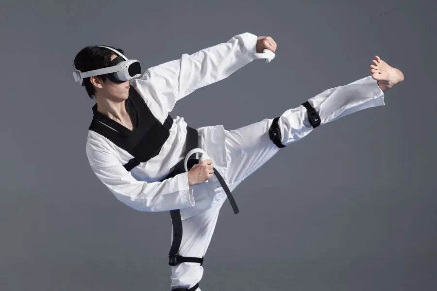مبارز تکواندو (Taekwondo) با عینک واقعیت مجازی (VR) در حال اجرای ضربه پا