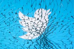 لوگو آبی سفید توییتر / Twitter در پشت شیشه شکسته