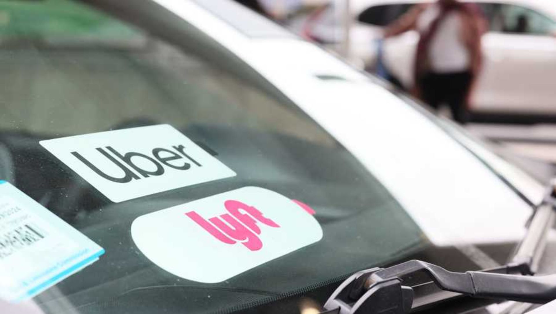 Uber and Lyft logo on the car window