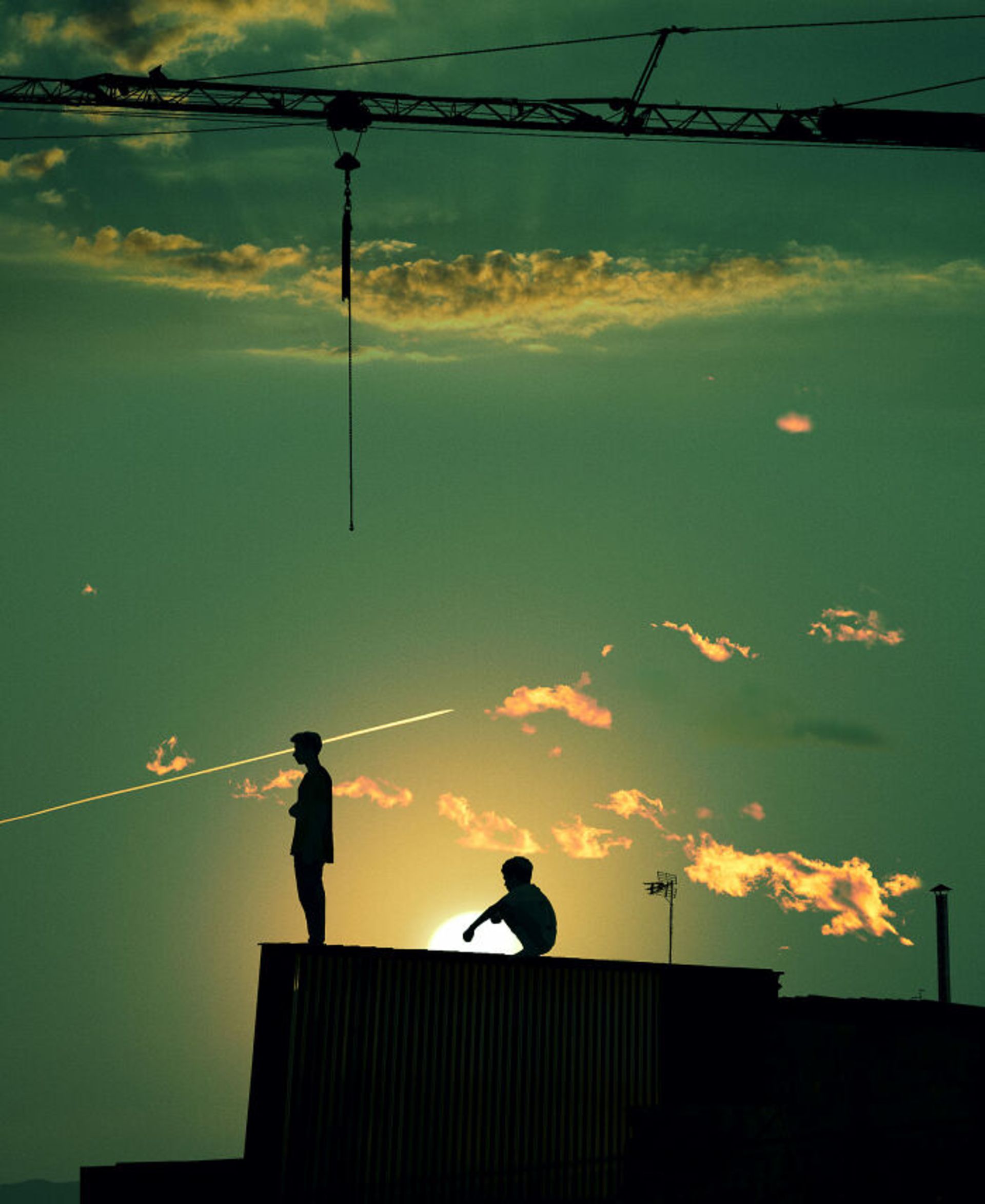 غروب آفتاب روی پشت بام سایه دو پسر