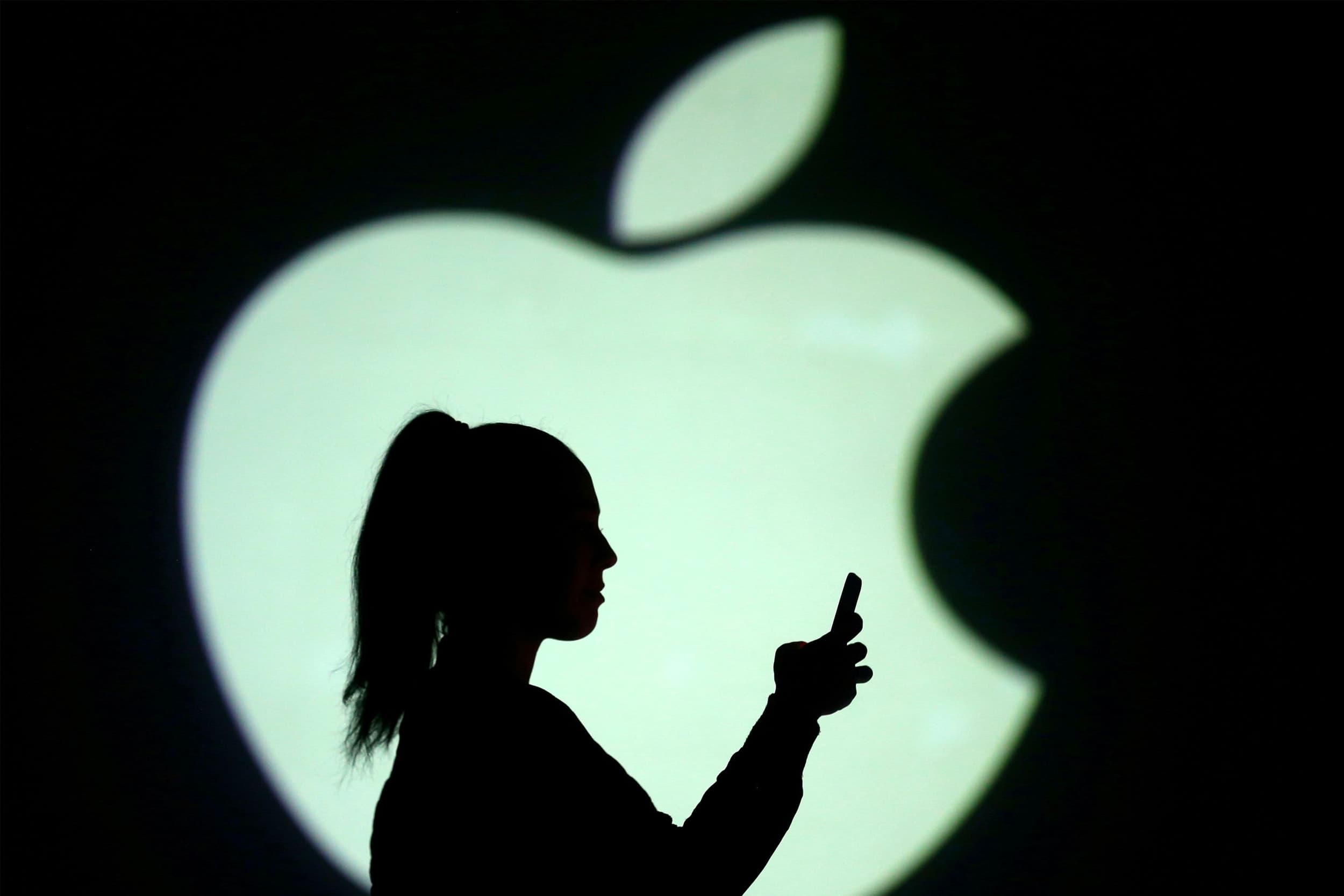 woman using phone apple logo shadow 6454daba2318e90d1ac22e90